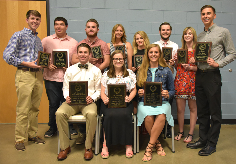 students holding plaques