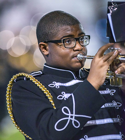 band member blowing trumpet