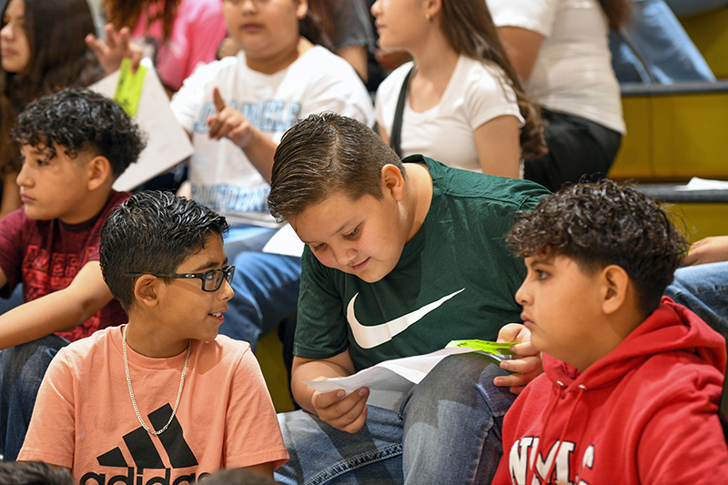 three boys looking at schedule