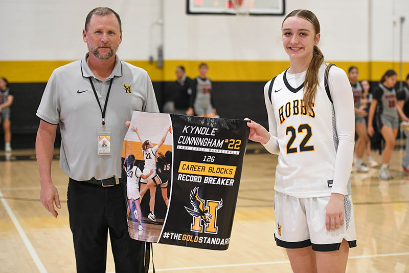 player and AD holding banner