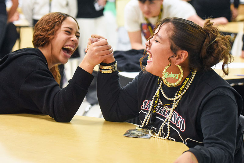 two girls arm wrestling