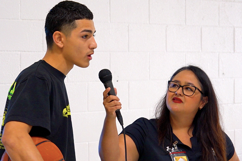 lady with microphone talking to student