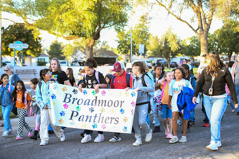 students walking with banner