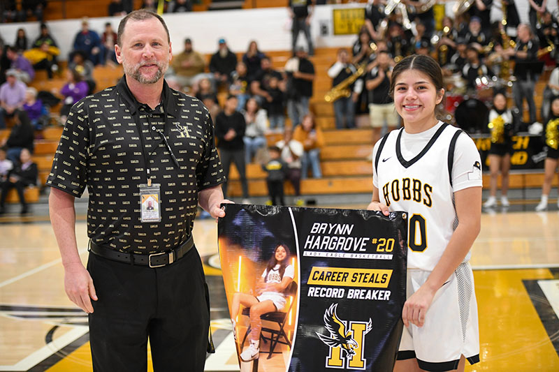 player holding banner with asst.AD