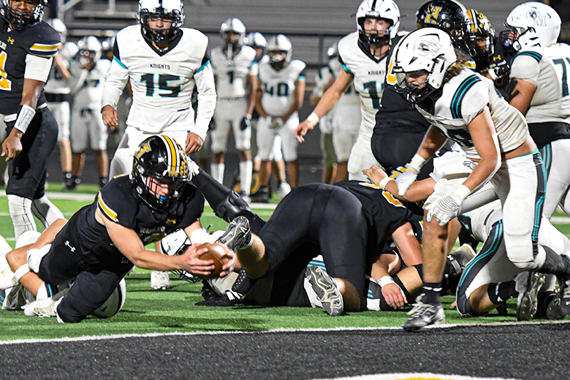 player extending ball across goal line